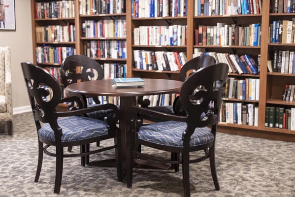 A common area with bookshelves and a table