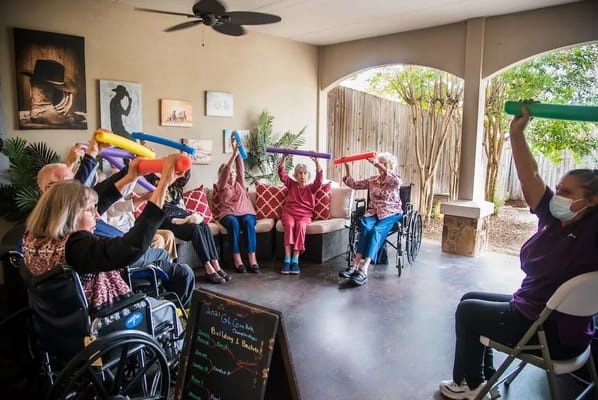 Residents participating in a group exercise activity outdoors