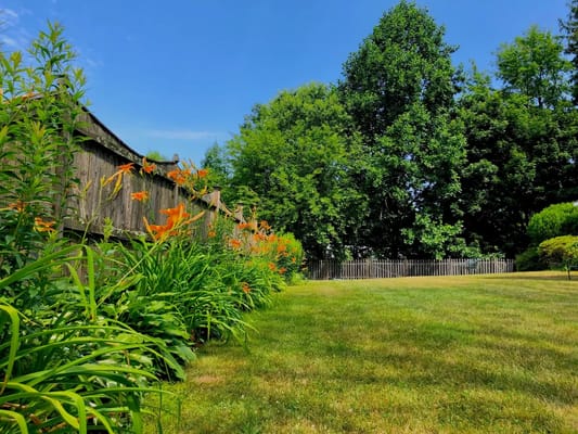 Well-maintained outdoor space with flower beds and trees