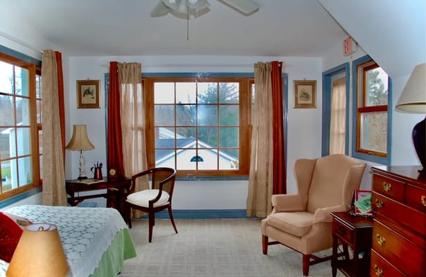 Cozy resident room featuring a bed and seating area