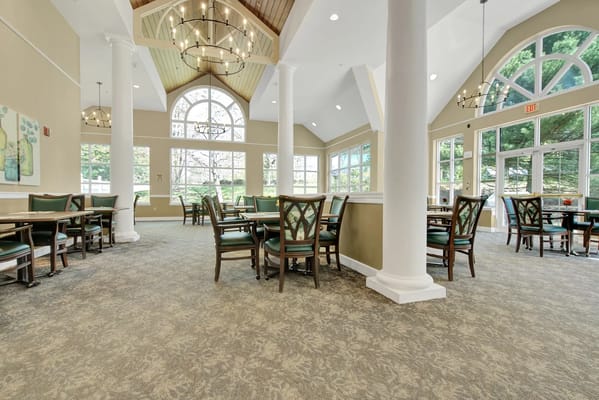 Bright and spacious dining room with tables and chairs
