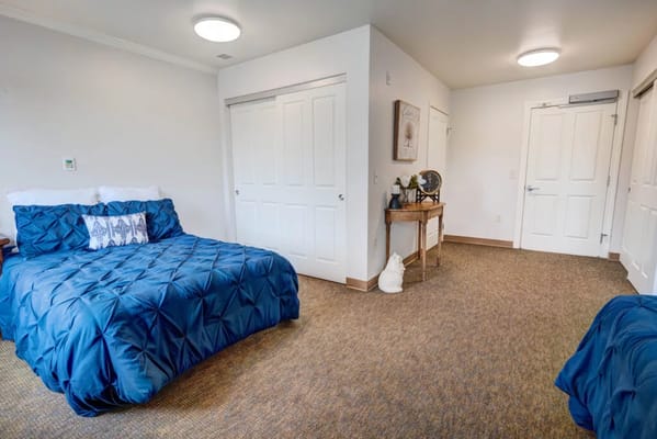 Bright and inviting bedroom with blue bedding and warm decor