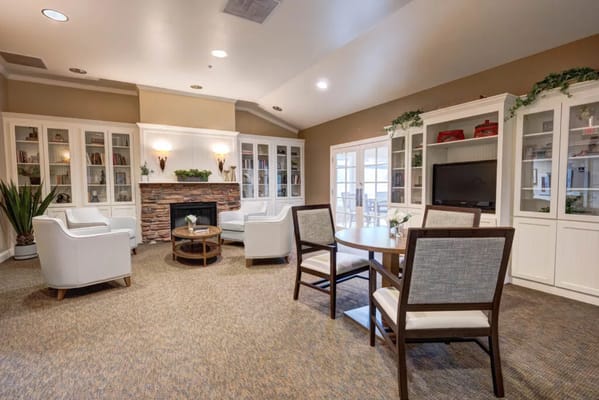 Inviting living room with white chairs and a fireplace