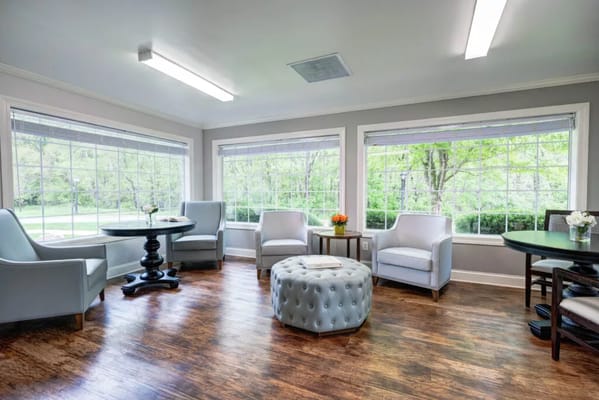 Bright lounge area with comfortable seating and large windows