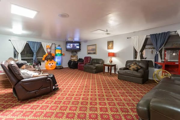 Comfortable living room area with recliners and festive decorations