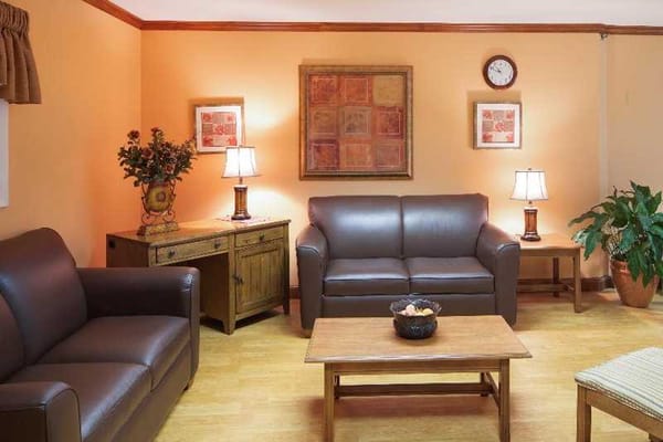 Comfortable lounge area with two couches, lamps, and a coffee table