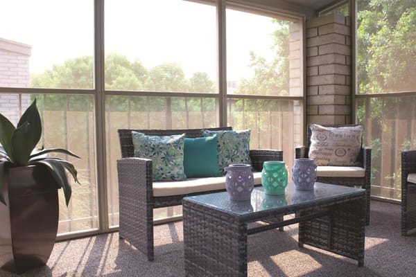 Bright glass-enclosed seating area with decorative accents