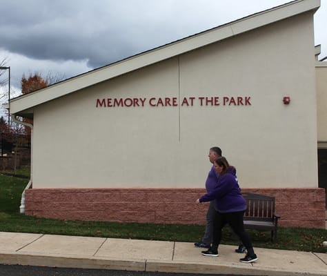 Residents walking by the facility exterior