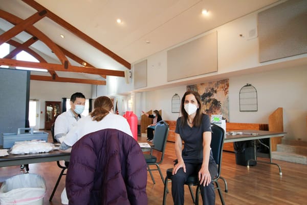 Staff attending to a resident in an indoor common area