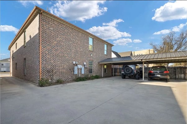 Exterior of Go Giver Assisted Living with parked cars
