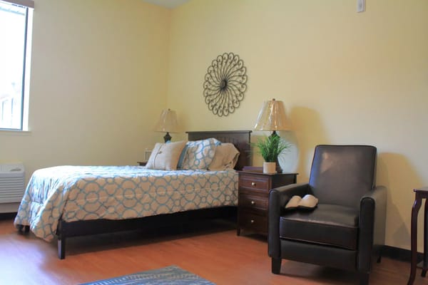 Cozy private resident room with a bed and chair