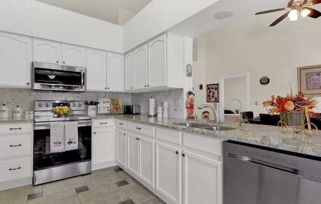 Bright kitchen area with modern appliances and decor
