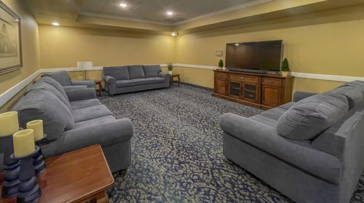 Lounge area with grey sofas and a television