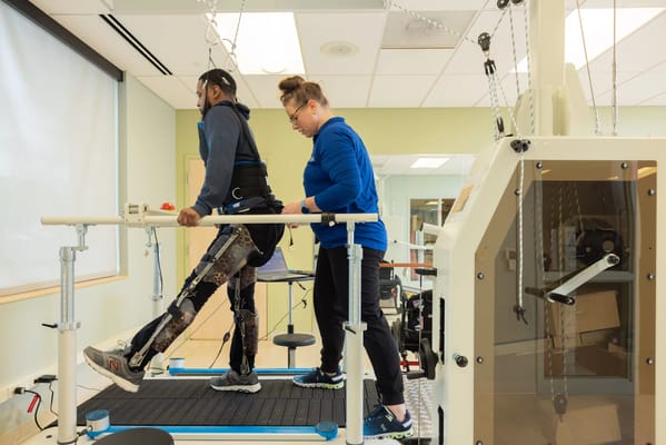 Resident undergoing physical therapy with assistance