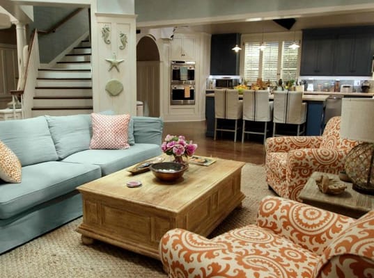 Bright common area with comfortable seating and a kitchen.