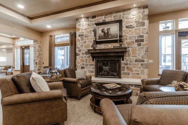 Cozy common area with seating and stone fireplace