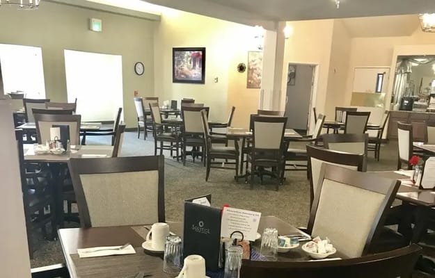 Dining area with tables and chairs in the facility