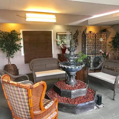 Seating area with a decorative fountain and plants