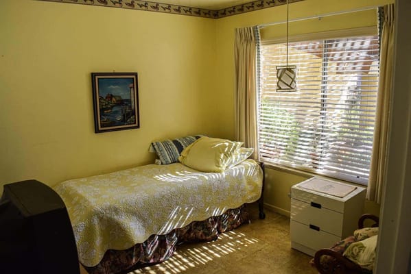 Cozy resident room with yellow walls and natural light