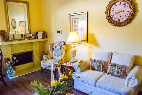 Cozy common area with floral decor and a clock
