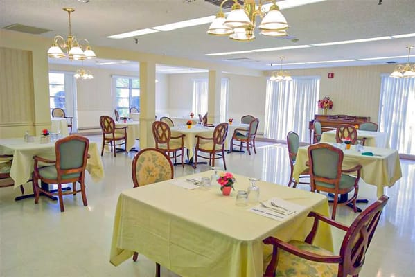 Bright dining room with tables set for meals