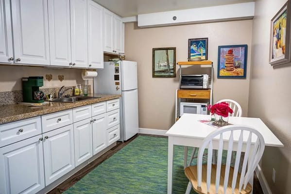 Light and airy kitchen with a dining table and artwork.