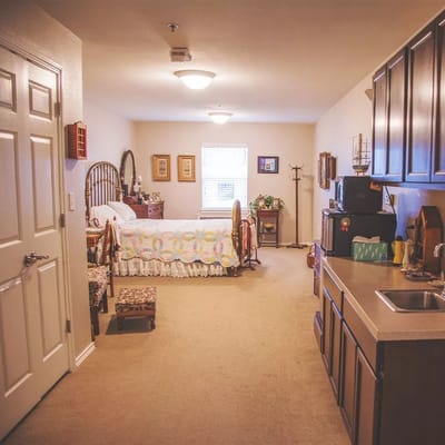 Cozy resident room with personal touches and kitchenette