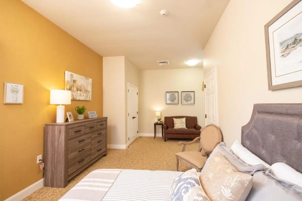 Cozy resident room with a bed and seating area