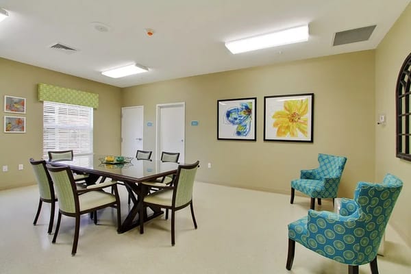Bright common area with dining table and artwork