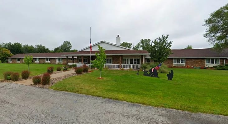 Exterior view of a senior living facility with garden
