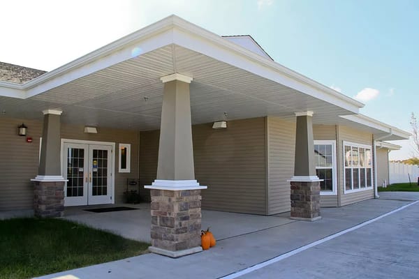 Exterior view of Windsor Manor entrance with pumpkins