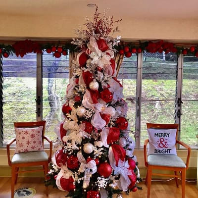 Festive Christmas tree with decor and holiday pillows
