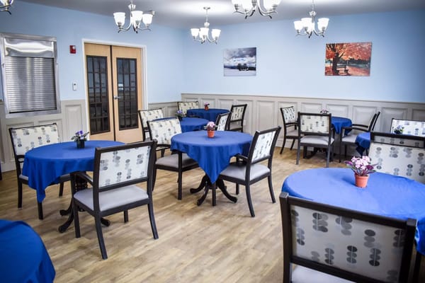 Dining room with blue tablecloths and chairs