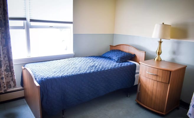 Cozy private room with a bed and lamp