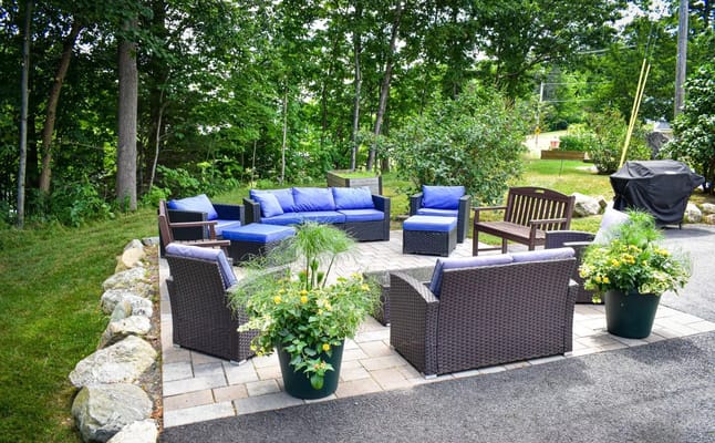 Outdoor seating area with plants and furniture