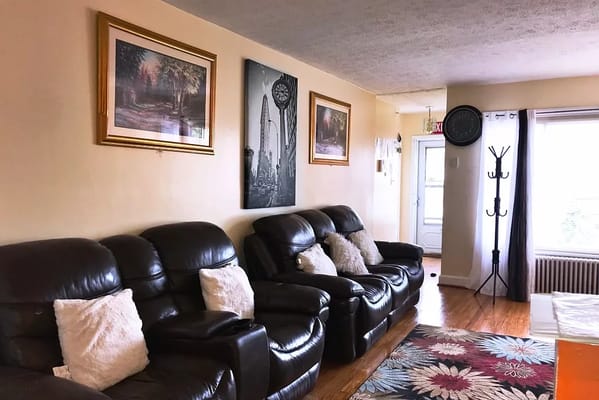 Living room area with leather seating and artwork on the walls