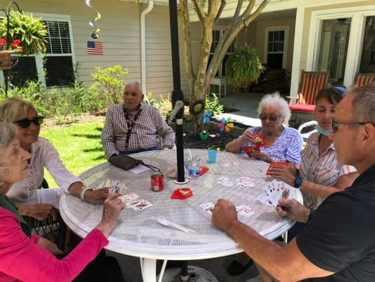 Residents engaged in a card game outside