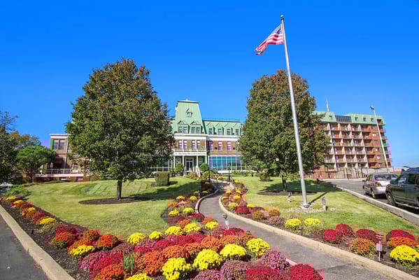 Exterior view of Harbour View Senior Living with colorful flowers