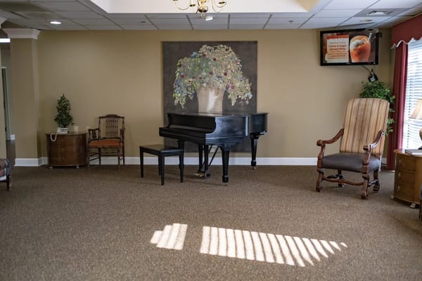 Common area with a piano and seating
