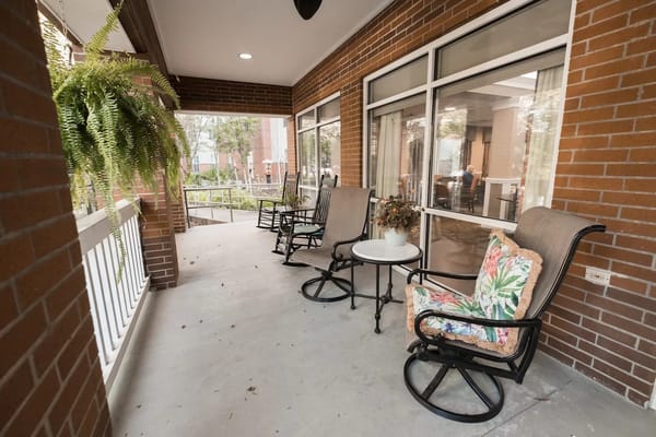 Covered outdoor seating area with rocking chairs