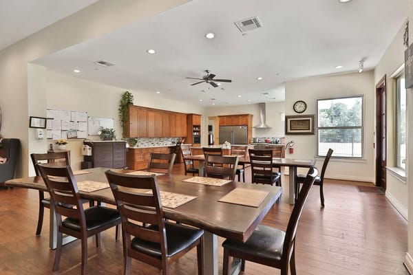 Well-lit dining area with large wooden table
