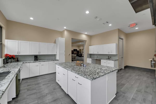Modern kitchen area with granite countertops