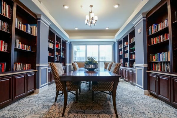Bright library with bookshelves and a wooden table