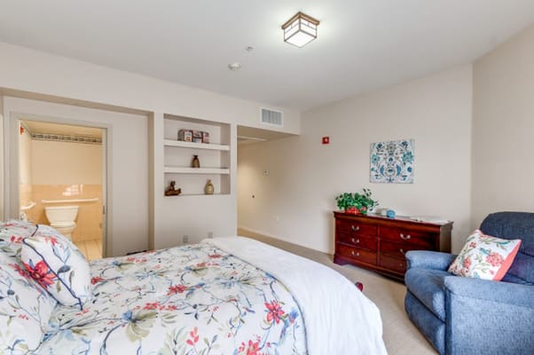 A cozy resident bedroom with floral bedding