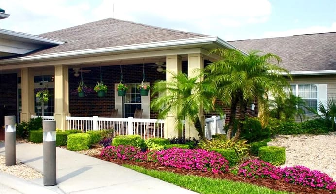 Patio area with landscaped garden and colorful flowers