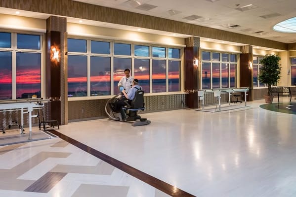 Interior view of a common area with staff and sunset