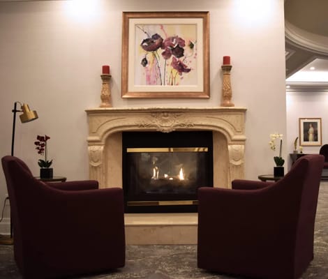 Cozy sitting area with a fireplace and artwork