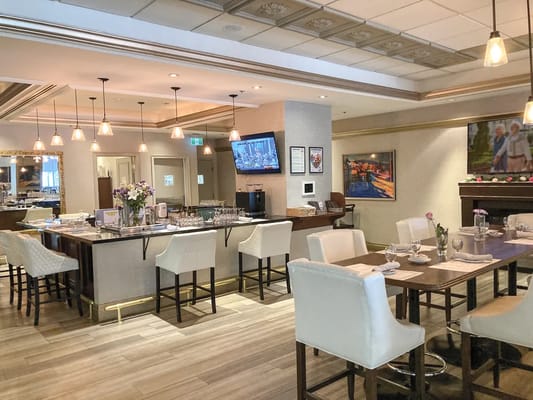 Bright dining area with tables and chairs set for meals