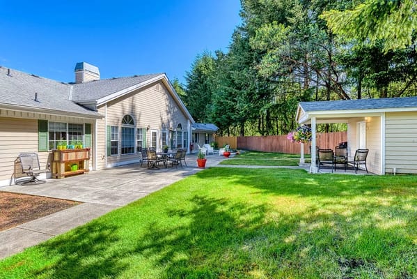 Outdoor patio area with seating and garden at Hearthside Manor.