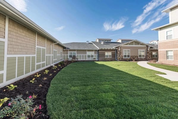 Green outdoor space with pathways and landscaping